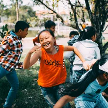 Kids playing tag outdoors at summer camp