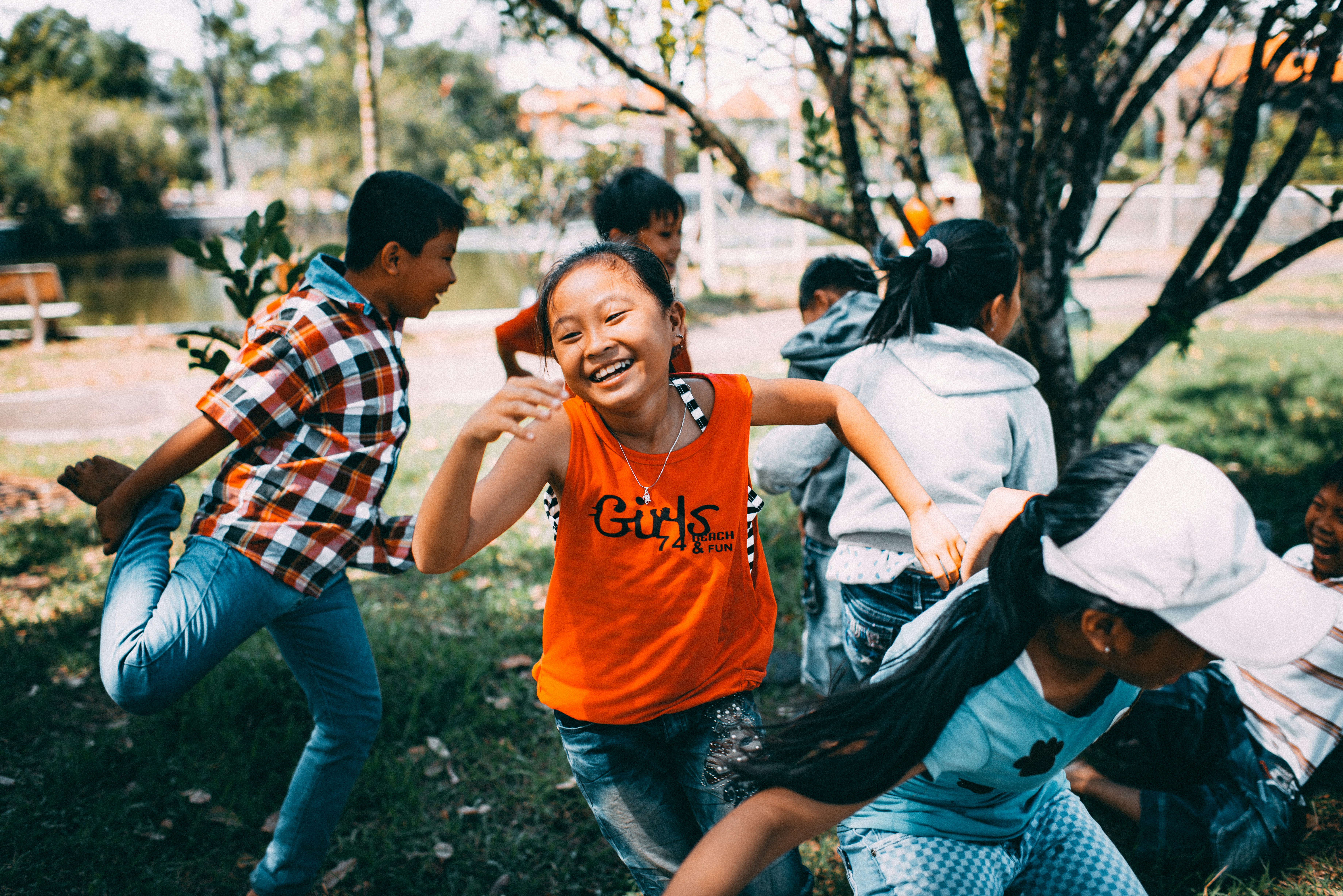 Kids playing tag outdoors at summer camp